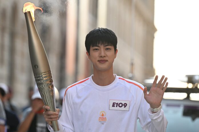 BTS' Jin carries the torch at the Olympic Torch Relay